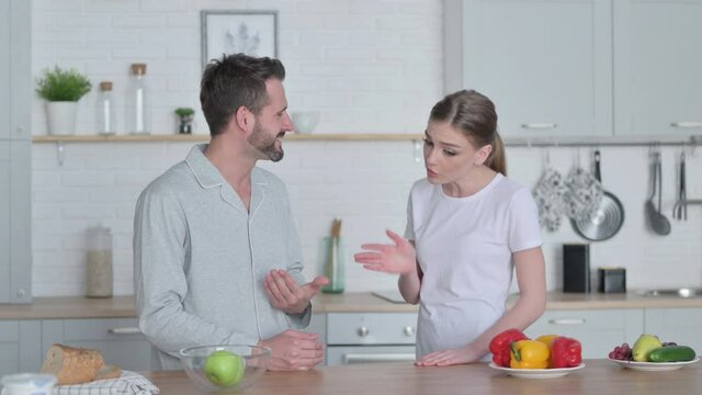 Young Woman Arguing with Man in Kitchen 