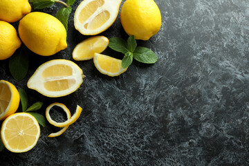 Ripe lemons on black smokey background, space for text