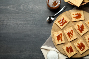 Tasty snack concept with cookies with caramel on dark wooden table
