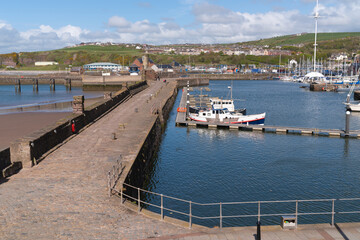 Whitehaven UK harbour wall with boats Cumbria coast near the Lake District