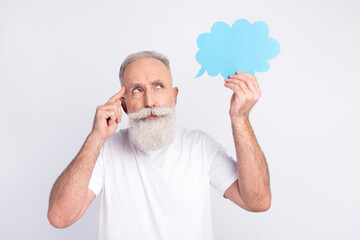 Portrait of attractive pensive man holding in hand cloud copy space deciding isolated over light grey color background