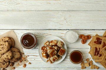 Tasty snack concept with cookies with caramel on white wooden table
