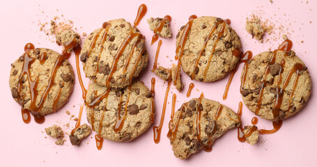 Cookies with caramel on pink background, space for text