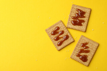 Cookies with caramel on yellow background, space for text