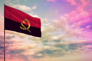 Fluttering Angola flag mockup with the space for your content on colorful cloudy sky background.