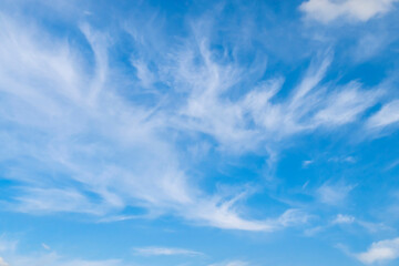 Naklejka na ściany i meble Blue sky background with cirrus white clouds, soft focus.