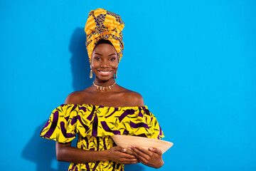 Photo of young positive beautiful african girl in tradition clothes hold clay vessel isolated on...