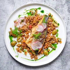 Sea bass, lentil and fennel ragout, wild garlic oil and green olives