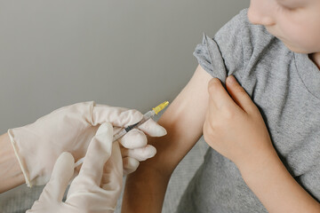 pediatrician vaccinating a little child in the pediatric clinic