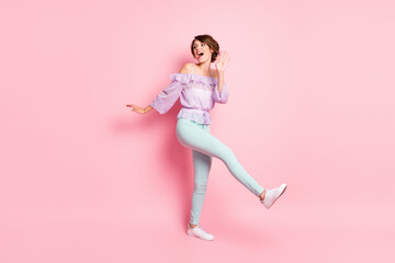 Fototapeta na wymiar Full size photo of young lovely pretty cute excited cheerful girl dancing look copyspace isolated on pink color background