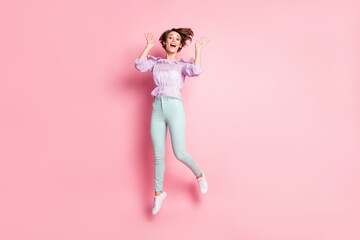 Fototapeta na wymiar Full length photo portrait of excited girl jumping up isolated on pastel pink colored background