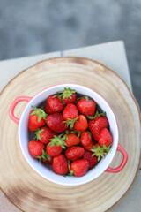Bowl of fresh strawberries on a table. Top view.