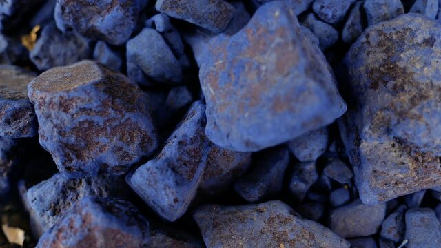 Moroccan blue, pure indigo rocks, natural dye stones. Dark blue abstract background footage.