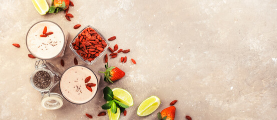 Healthy blended diet smoothie drink with strawberry and goji berries, chia seeds and lime. Top view