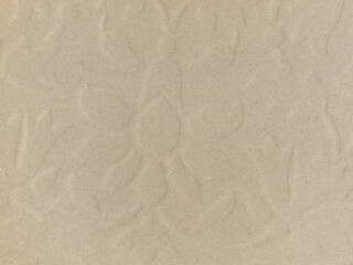 Fototapeta na wymiar Cardboard background with an embossed floral pattern in an irregular shape. 