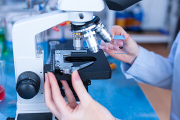 Girl laboratory Assistant.works with an antiviral drug in a laboratory