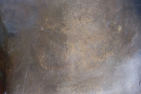 The texture of the worn bronze or brass background is covered with a patina	
