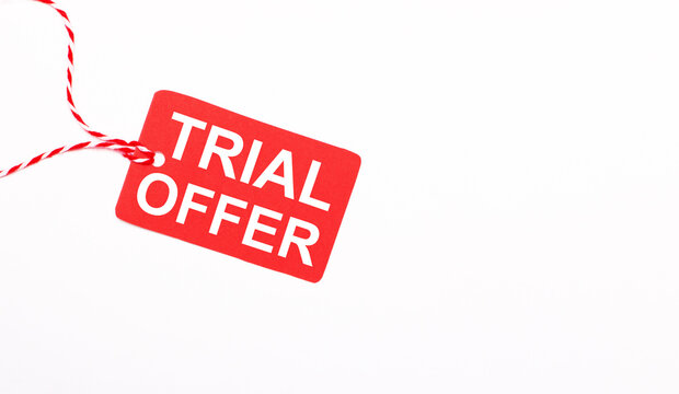 The inscription TRIAL OFFER on a red price tag on a light background. Advertising concept. Copy space