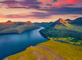 Aerial landscape photography. Great sunset on Faroese fjords in the outskirts of Funningur village....