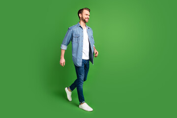 Full length body size side profile photo of confident man wearing stylish clothes smiling isolated bright green color background