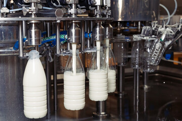 filling milk in to plastic bottles at the factory. equipment at the dairy plant