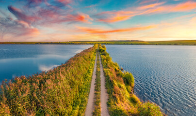 Obraz premium Gorgeous summer sunrise on Vertelka lake, Ternopil region. Impressive morning view from flying drone of Ukrainian countryside. Traveling concept background.