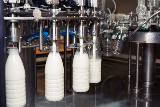 filling milk in to plastic bottles at the factory. equipment at the dairy plant