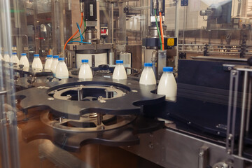 filling milk in to plastic bottles at the factory. equipment at the dairy plant