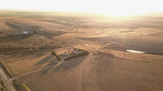 Aerial Shot Of Harvested Field Against Clear Sky, Structures Over Agricultural Field On Sunny Day - Oakley, Kansas