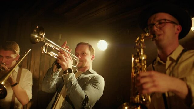 HANHDHELD CU Portrait of jazz band members playing brass instruments on stage during a live concert in small venue. Shot on ARRI Alexa Mini with 2x anamorphic lens