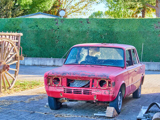 Antique red car ready for restoration, collector's scrap. Need to fix bodywork, paint and mechanics in general of an old car.
