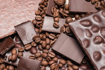 coffee beans close-up and chocolate. Dark chocolate bar. Natural background of cinnamon color.