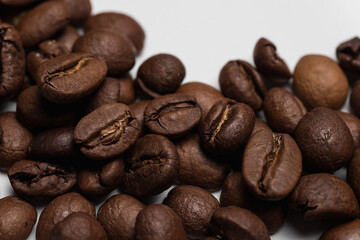 Naklejka premium Coffee beans close-up. The natural background is brown. Lots of coffee.