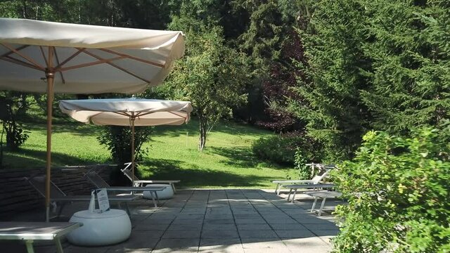 Resort sun shades and sun loungers in landscape, Alta Badia, Italy
