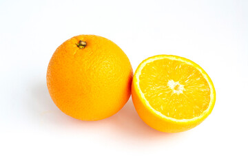 A ripe orange and a half isolated on a white background