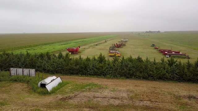 Aerial Forward Shot Of Irrigation Equipment Over Green Landscape In Field Against Clear Sky - Oakley, Kansas