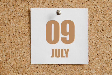 july 09. 09th day of the month, calendar date.White calendar sheet attached to brown cork board.Summer month, day of the year concept