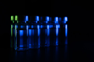 Glass medical ampoule vial for injection. Medicine is dry white drug penicillin powder or liquid with of aqueous solution in ampulla. Close up.