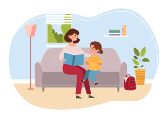 Young mother is reading book to little daughter at home seated on a comfortable couch in the living room