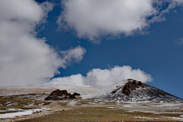 Western Mongolia. The clouds on the snow-covered high-altitude steppes seem very low due to the high altitude (2500-3000m above sea level).