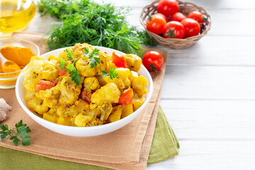 Curry from potatoes and cauliflower - vegetarian vegetable dish, selective focus. Copy space