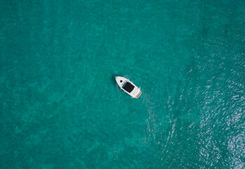 White yacht on blue water top view