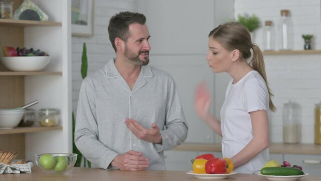 Young Woman Arguing with Man in Kitchen 