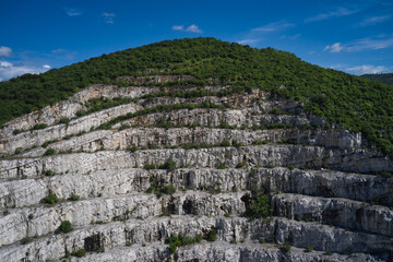 Fototapeta na wymiar Italian marble quarries. Aerial view of an abandoned marble quarry. Panorama of developed mountain fossils. Top view of used mining in the alps.
