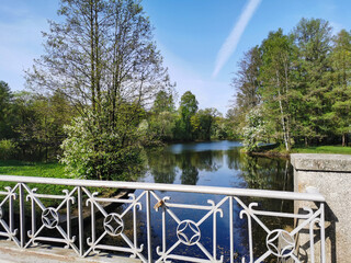 Figure fence of the bridge over the canal on a sunny spring day in the park on Elagin Island in St. Petersburg.