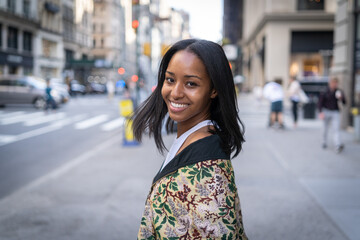 Fototapeta premium Young black woman in city flirting with camera sexy smile face