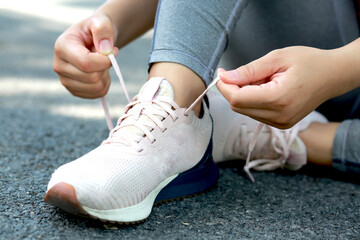 A woman tying shoelaces