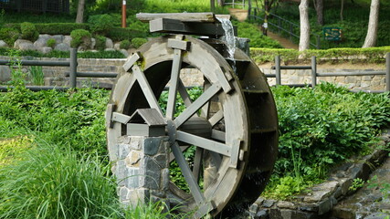 Fototapeta na wymiar Water Wheel on the Park at Sunny Day Spring