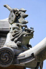 Fototapeta na wymiar Fukuoka, Japan-Apr 26,2011:sculpture on the ancient japan roof