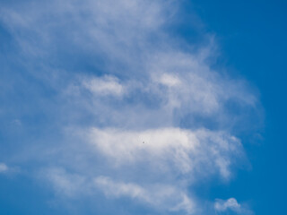 Naklejka na ściany i meble Unusual white clouds in form of evil face in blue sky